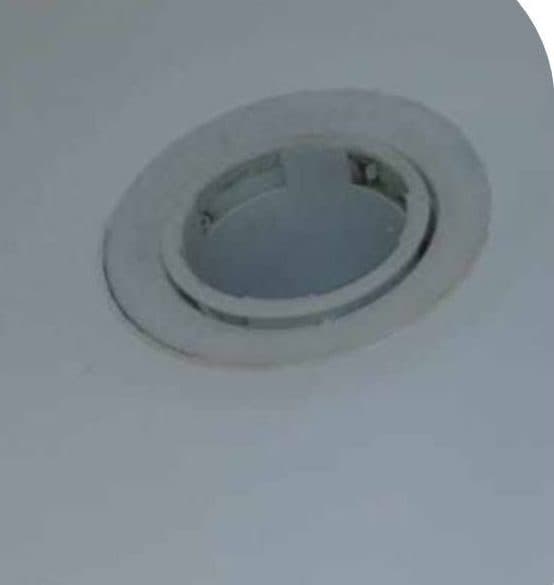The same extractor housing after cleaning, the white surround and metal rim clear