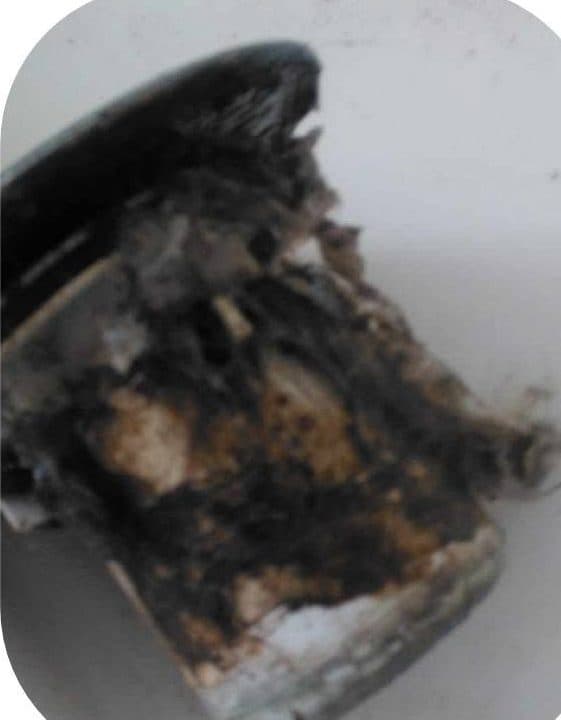 An extractor filter unit thick with hardened black and brown grease